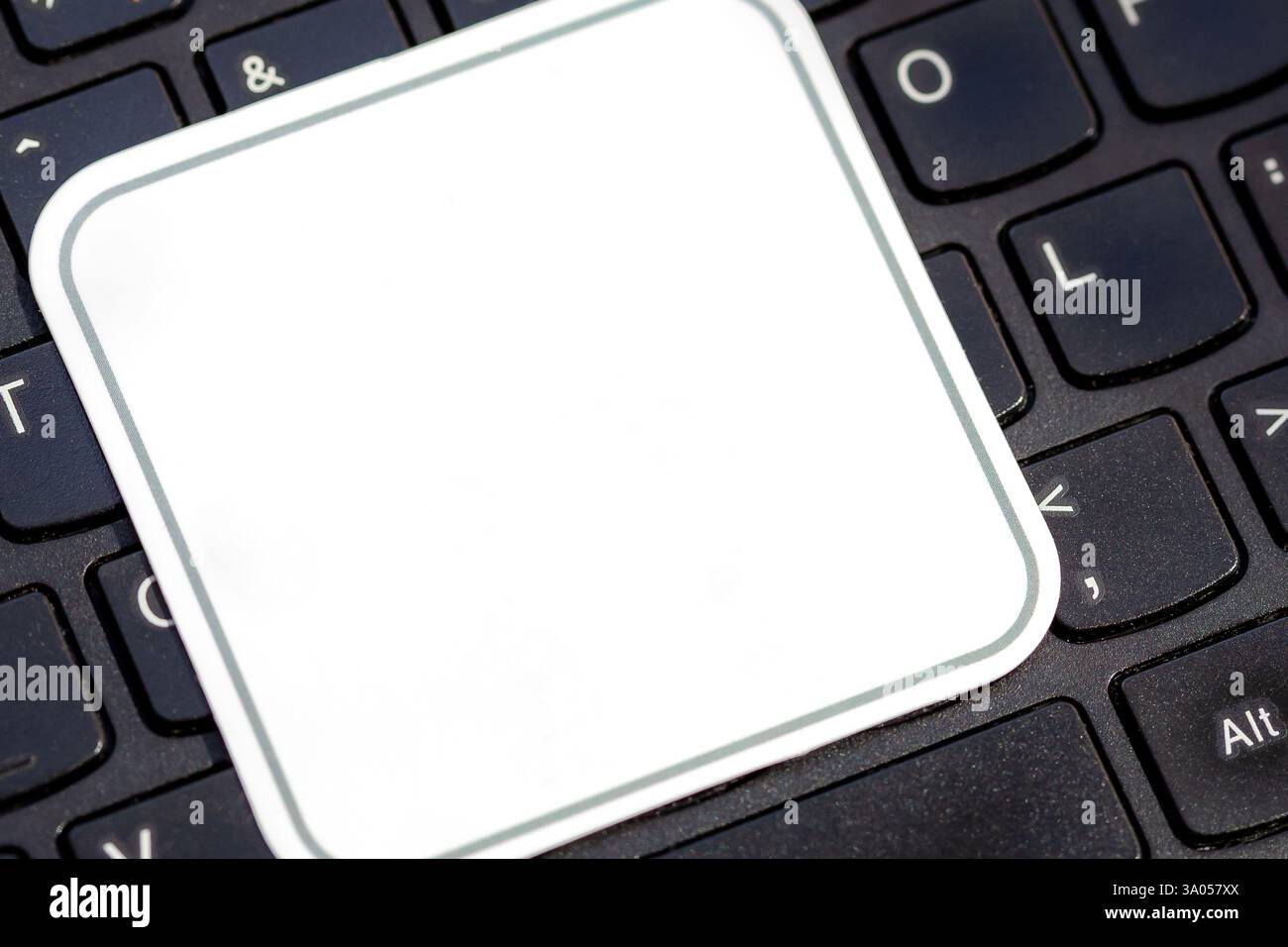 Simple blank white square label on a laptop computer keyboard, empty ...