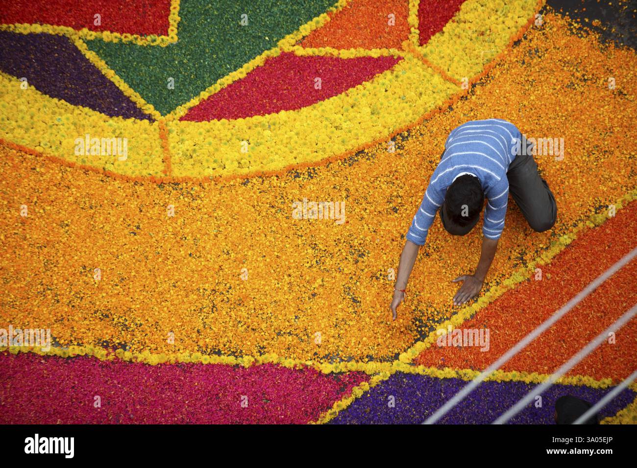 Residents making colourful flower Rangoli on road for immersion ...