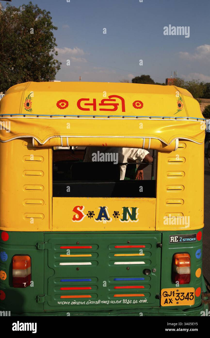Yellow and green auto rickshaw on street of Ahmedabad, Gujarat, India ...