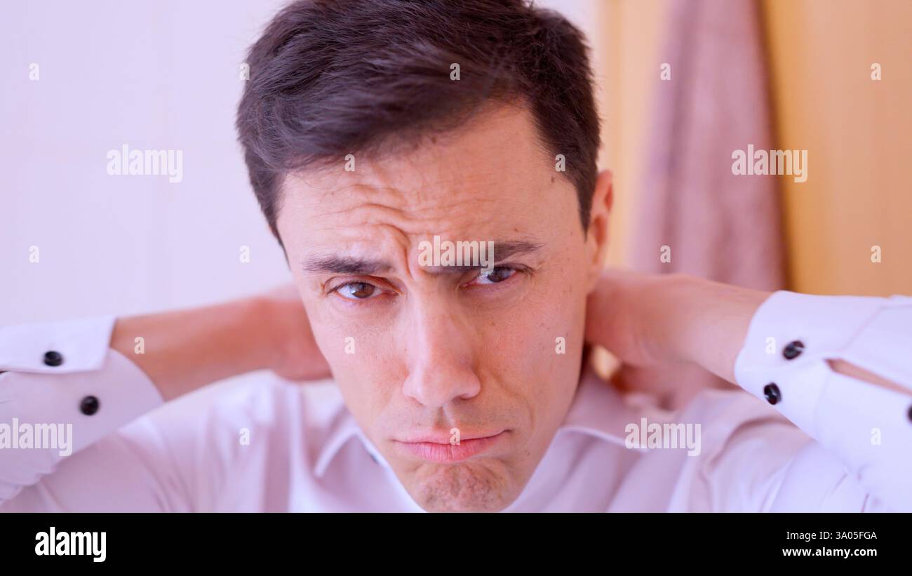 Successful businessman gets dressed in the bathroom Stock Photo