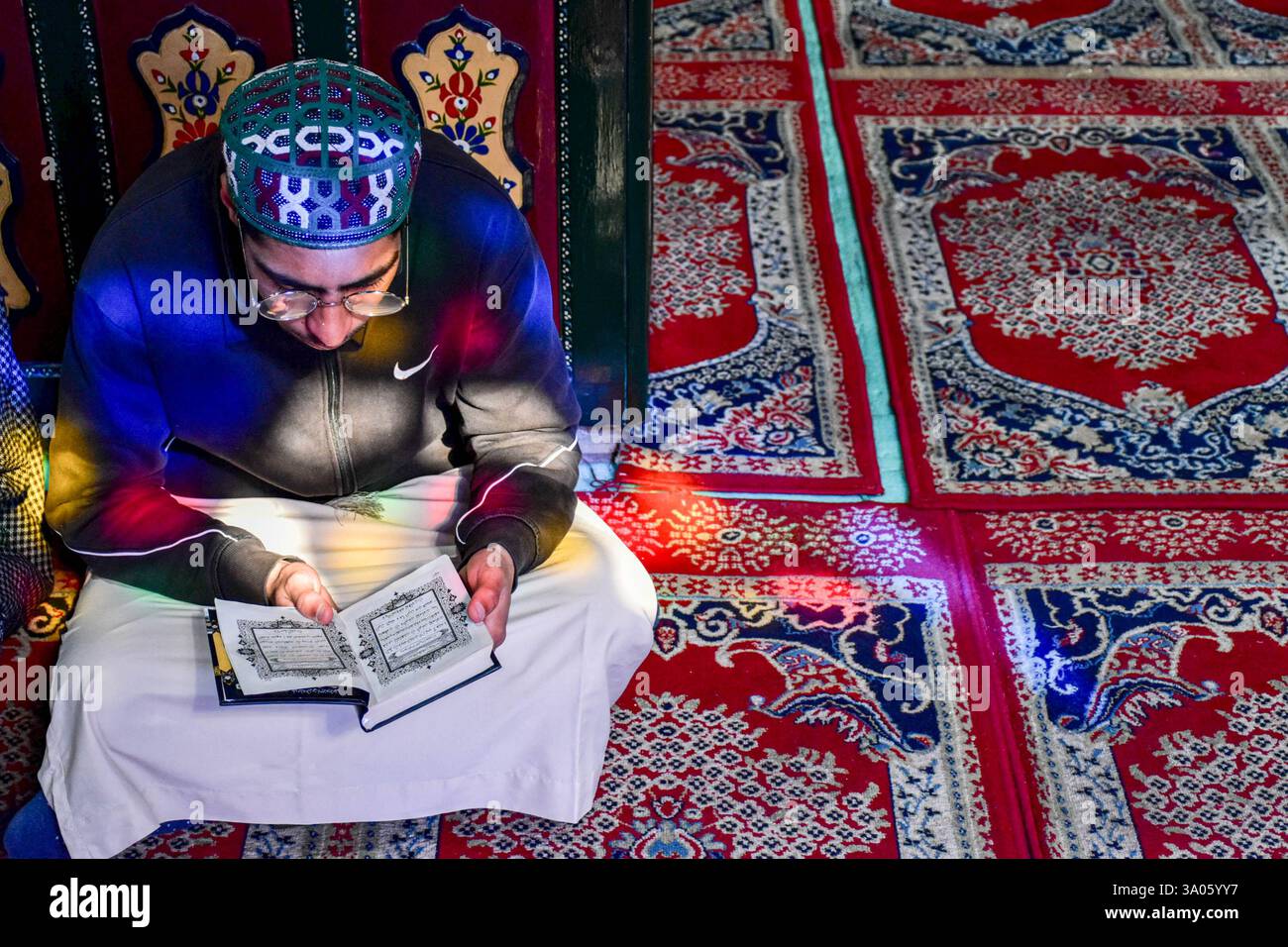 A Kashmiri Muslim recites the Holy Quran inside the shrine of Syed ...