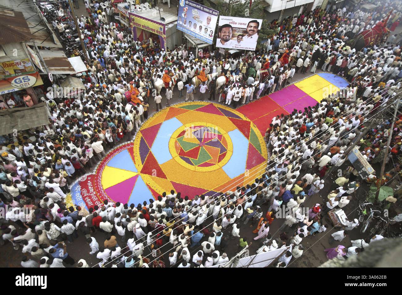 Grand colourful flower Rangoli made on road for immersion celebration ...