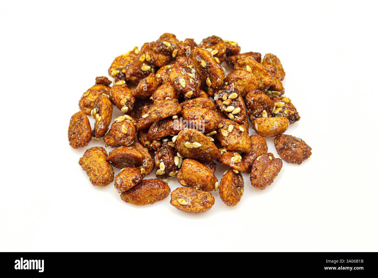 Pile of sweet caramelized peanuts with sesame isolated on white background Stock Photo