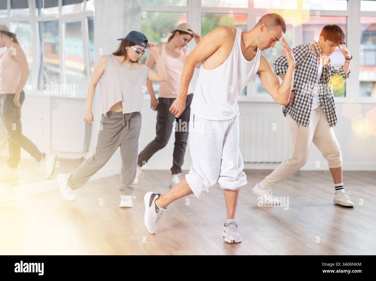 Hip-hop dance performed by group of young dancers in dance studio Stock Photo