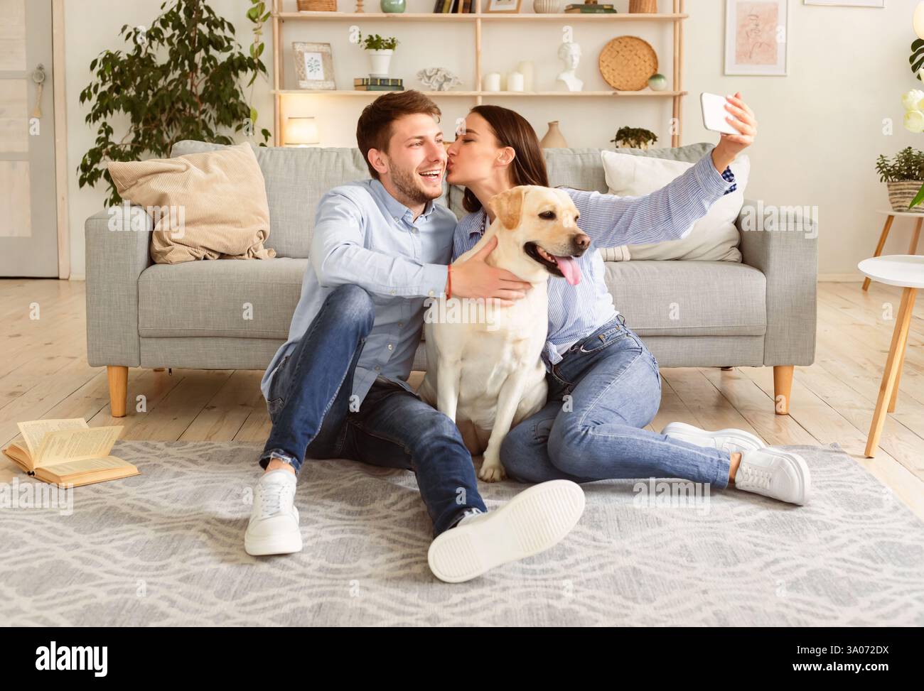 Young couple kissing hugging dog hi-res stock photography and images ...