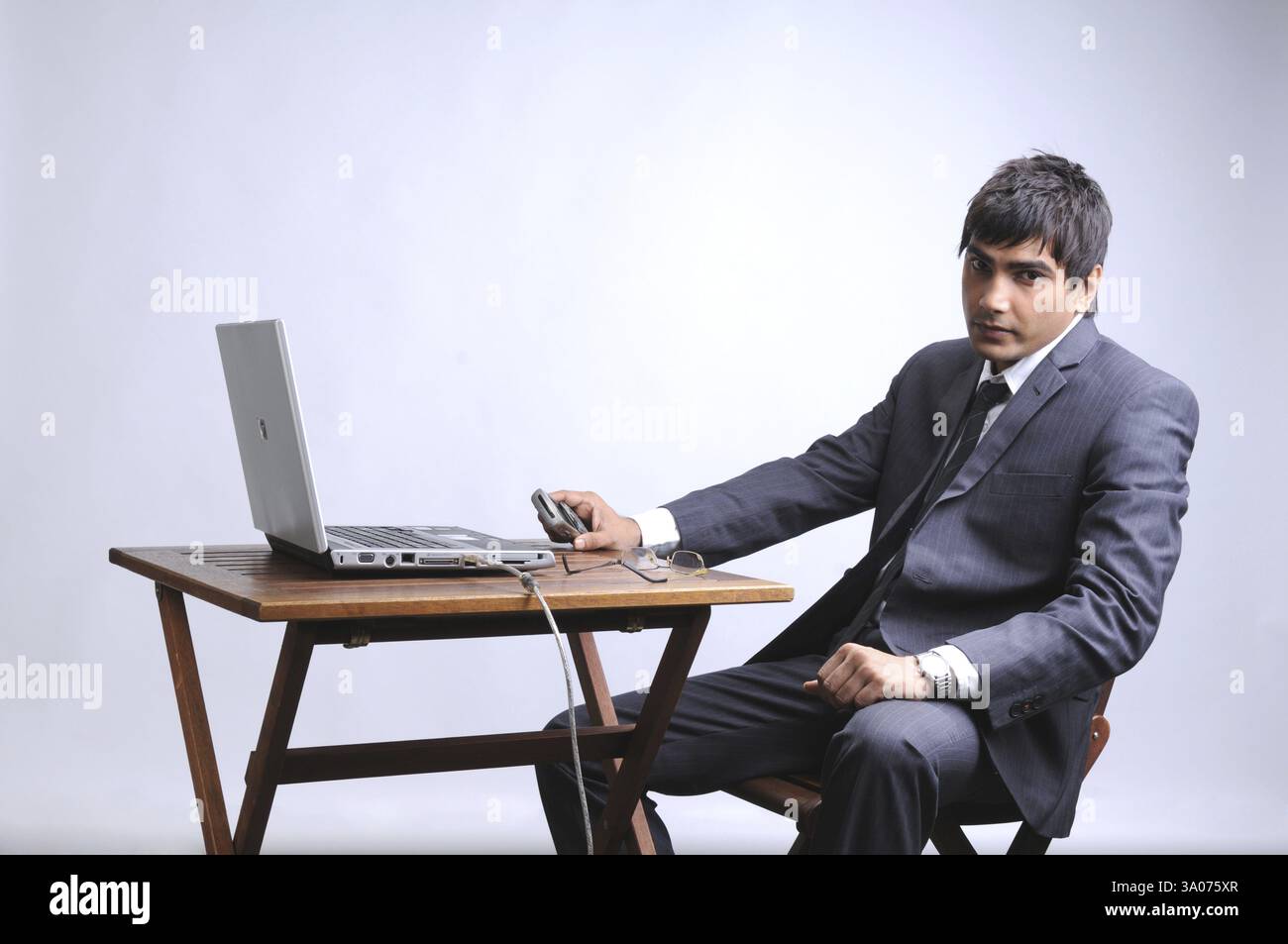 Man in formal attire sits hi-res stock photography and images - Alamy