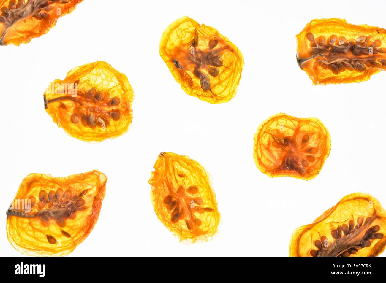 Sliced dried cherry tomatoes on a white background Stock Photo