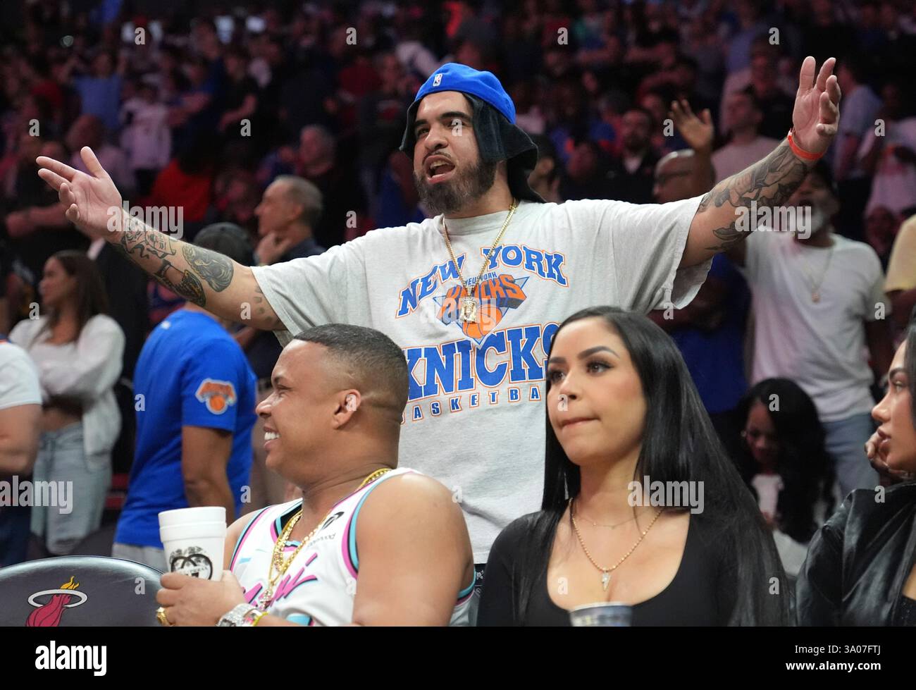A New York Knicks fan cheers during overtime in an NBA basketball game ...
