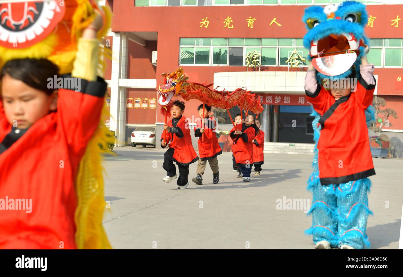 Children perform at a kindergarten to celebrate Longtaitou Festival in