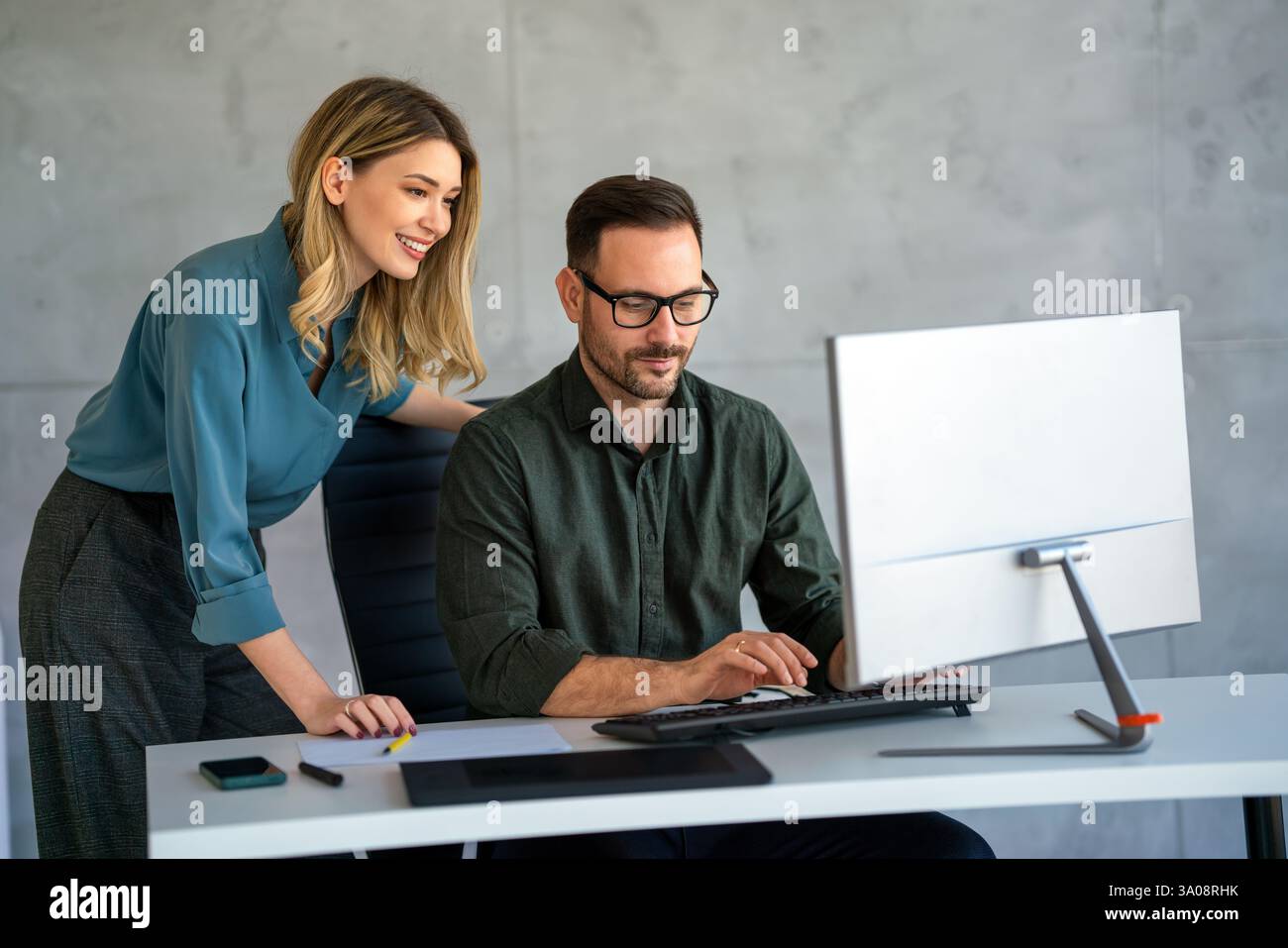 Business professionals collaborating on a project in a modern office ...