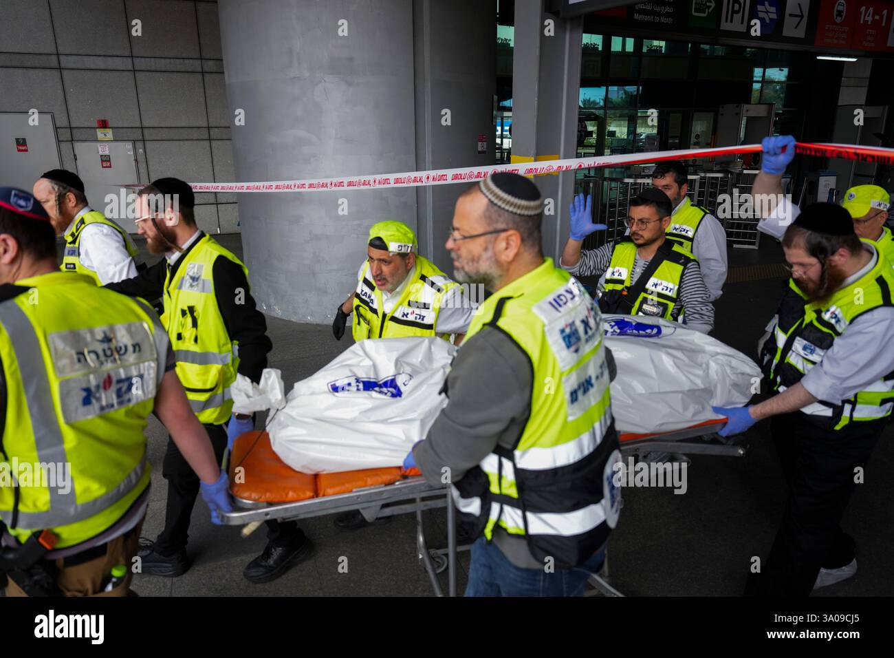 Members of ZAKA rescue services carry the body of a 70-year-old killed ...
