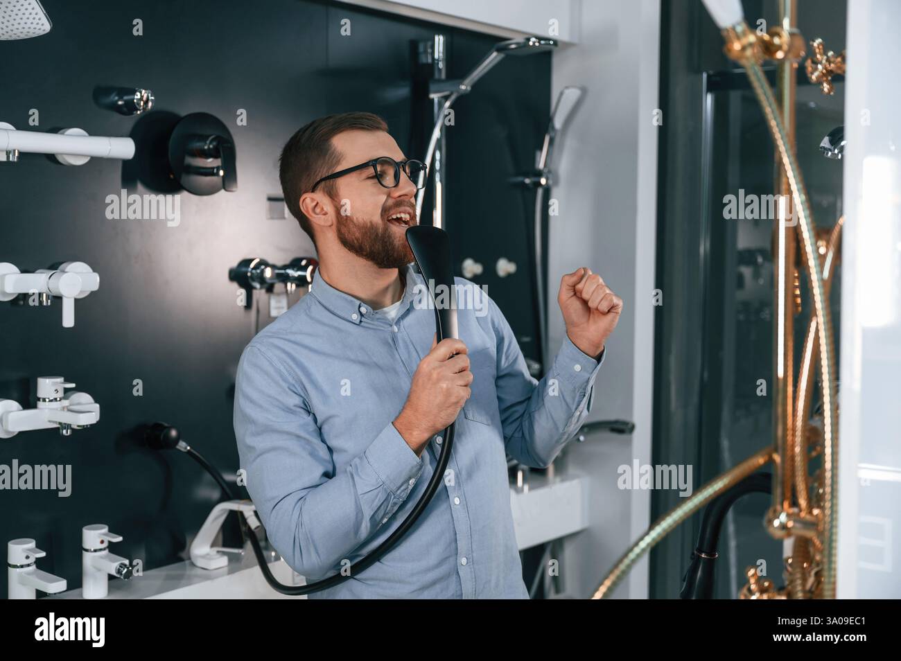 Using faucet as microphone, singing. Man chooses a products in a ...
