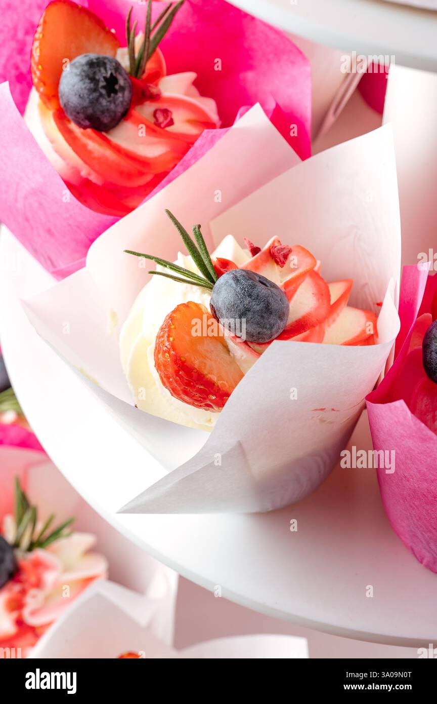 cupcakes with berries on a stand Stock Photo