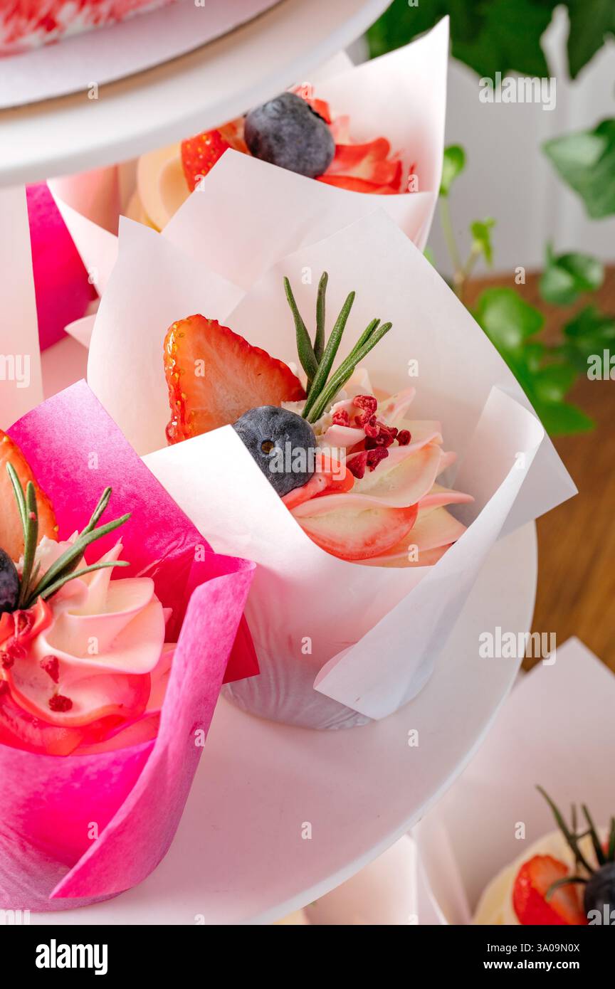 cupcakes with berries on a stand Stock Photo