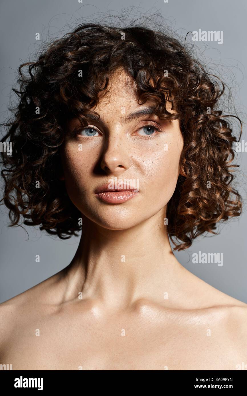 A young woman with curly hair and blue eyes showcases her natural ...