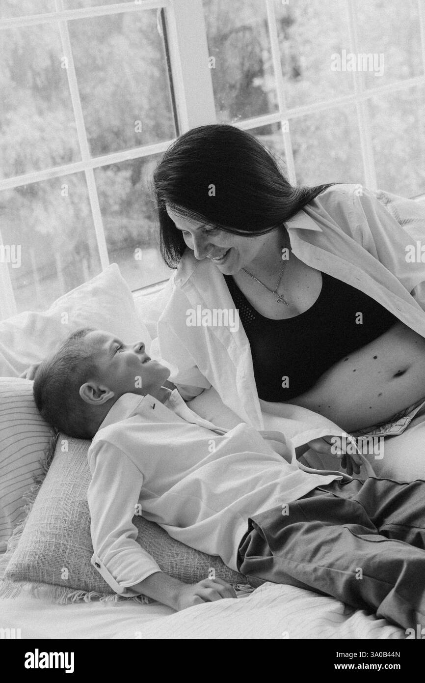 Family pregnancy photoshoot with father, pregnant mother, and son Stock Photo