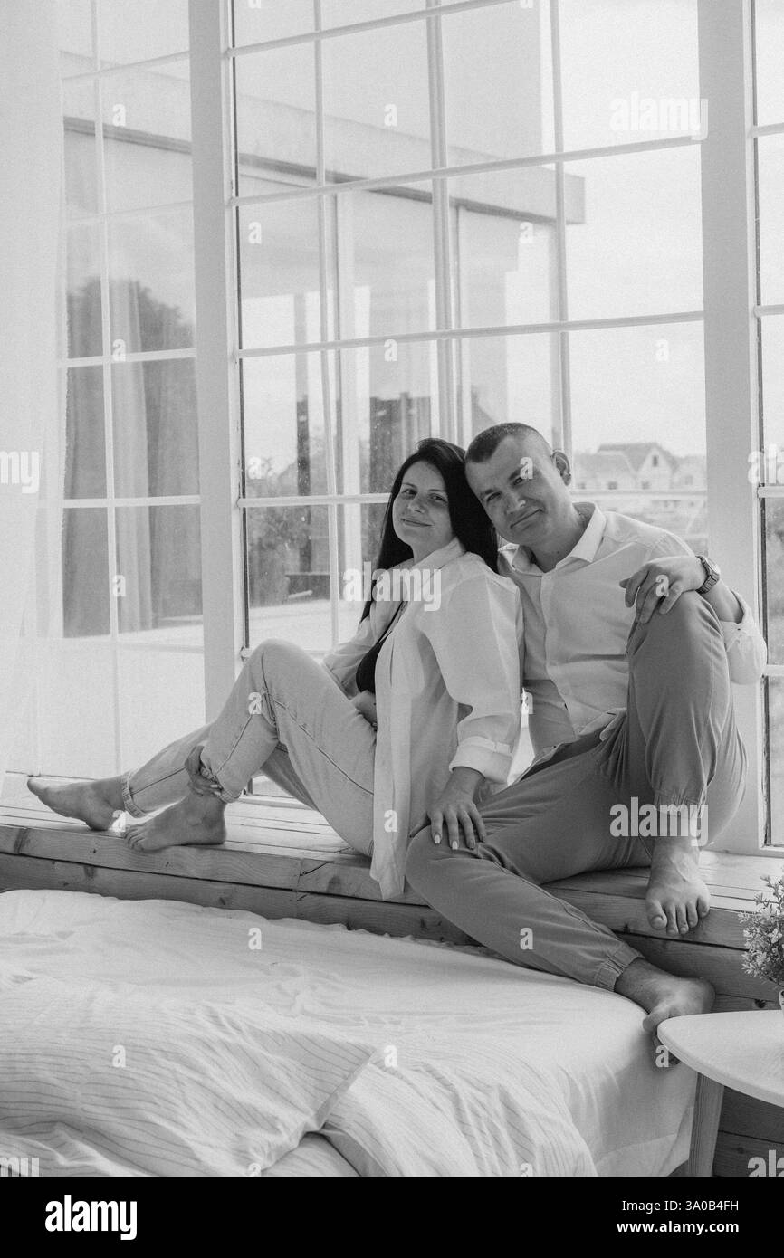 Family pregnancy photoshoot with father, pregnant mother, and son Stock Photo