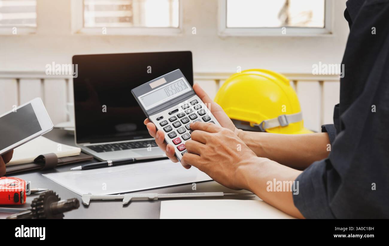 The engineering team is working on their project together. Stock Photo