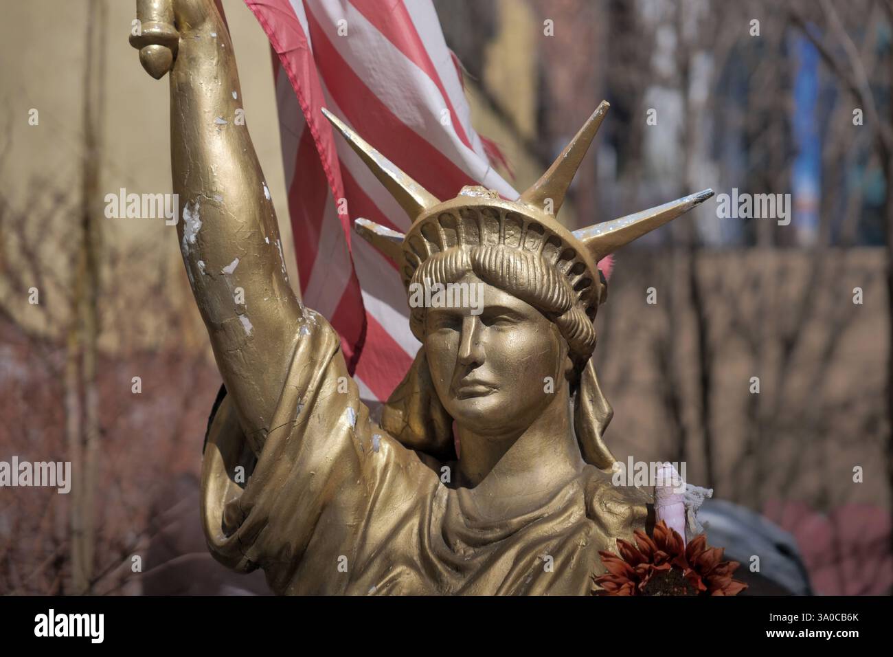 New York, New York, USA. 1st Mar, 2025. Battered and bruised behind a fence but still standing this copy of.the Statue of Liberty found in a lot in the Meatpacking District NYC.Surrounded by discarded pieces of sculpture, castaway junk, garbage.Lady Liberty perhaps part of an art project rises painted in gold. (Credit Image: © Milo Hess/ZUMA Press Wire) EDITORIAL USAGE ONLY! Not for Commercial USAGE! Stock Photo