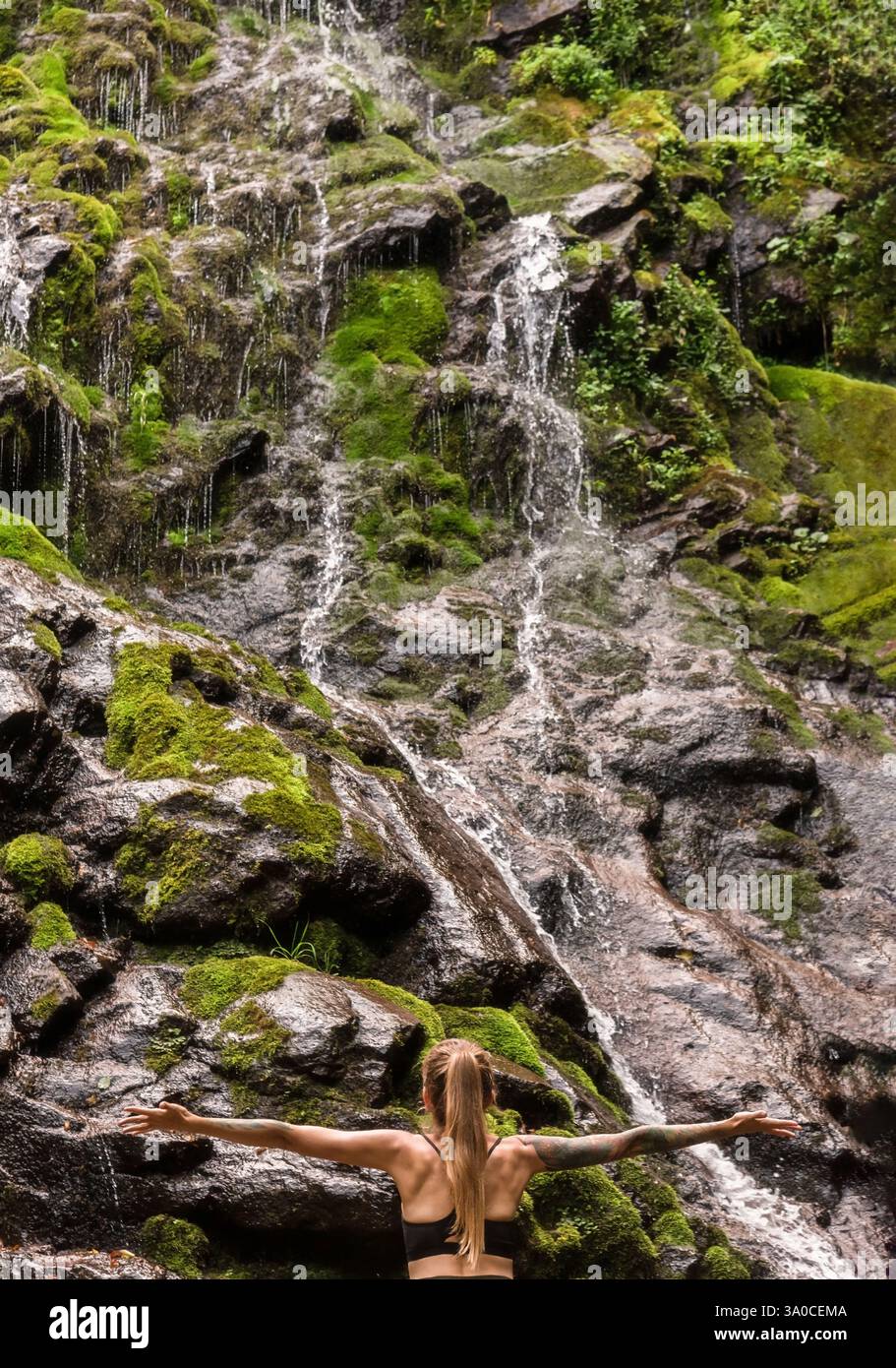 Woman Tourist Standing by Waterfall with Hands Outstretched Stock Photo ...