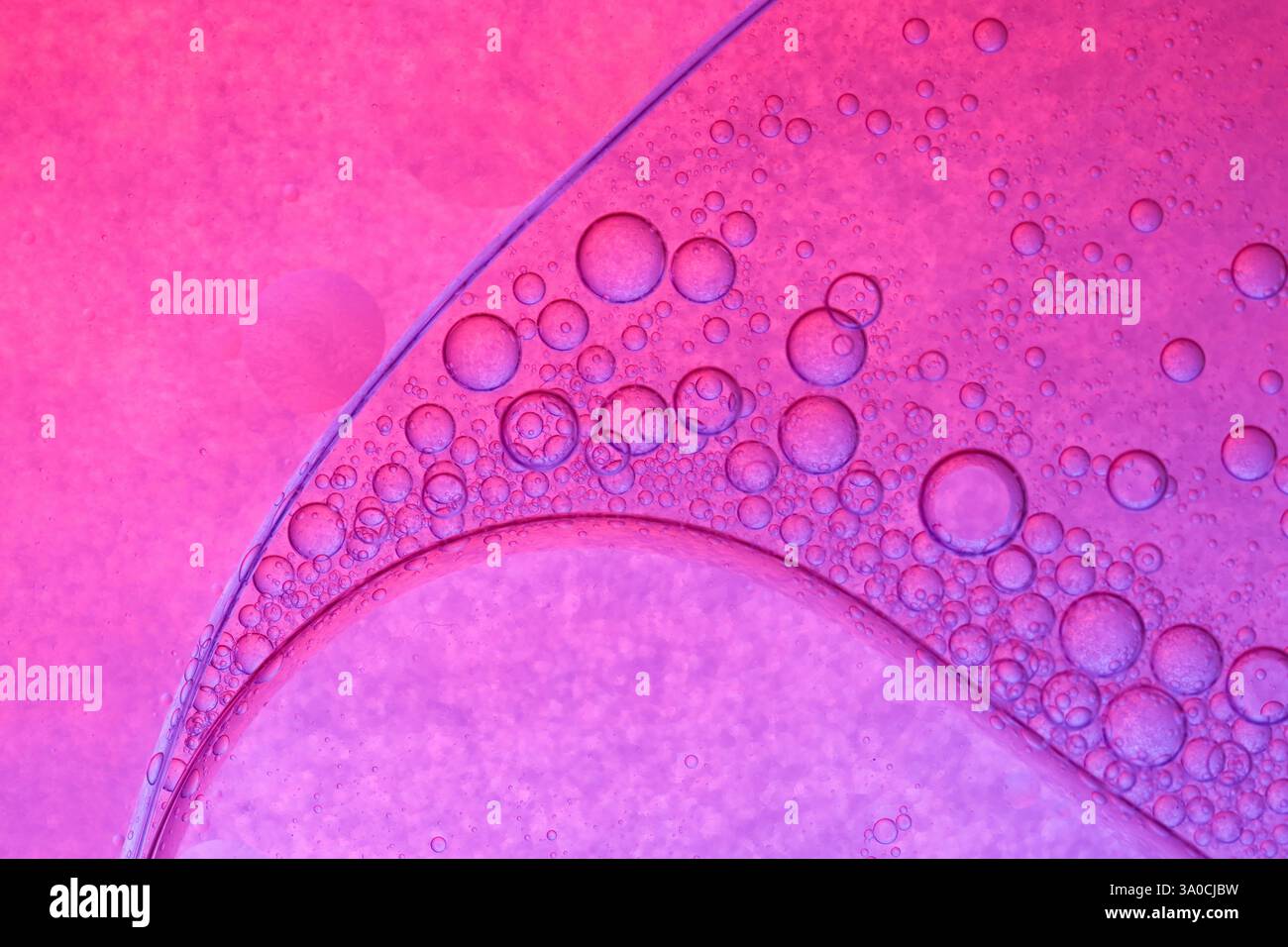 Pink circles on oily surface Stock Photo