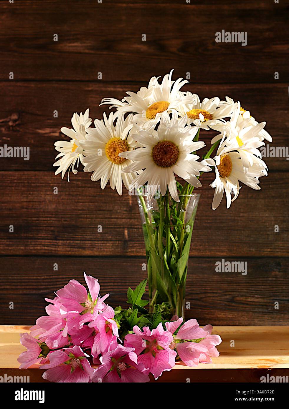 Bouquet of beautiful chamomile and mallow flowers in vase on wooden ...