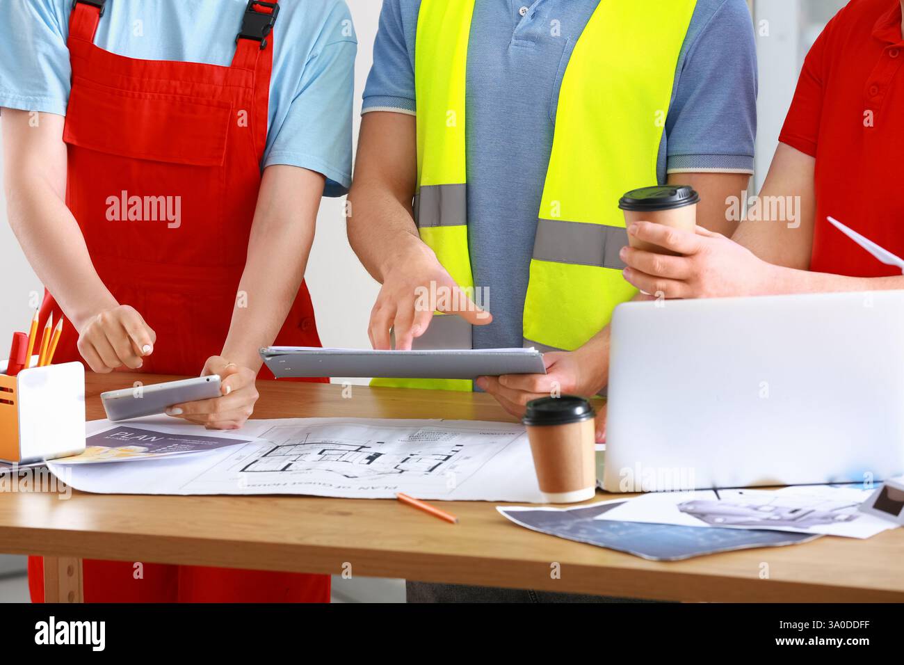 Team of constructors working at table in office, closeup Stock Photo
