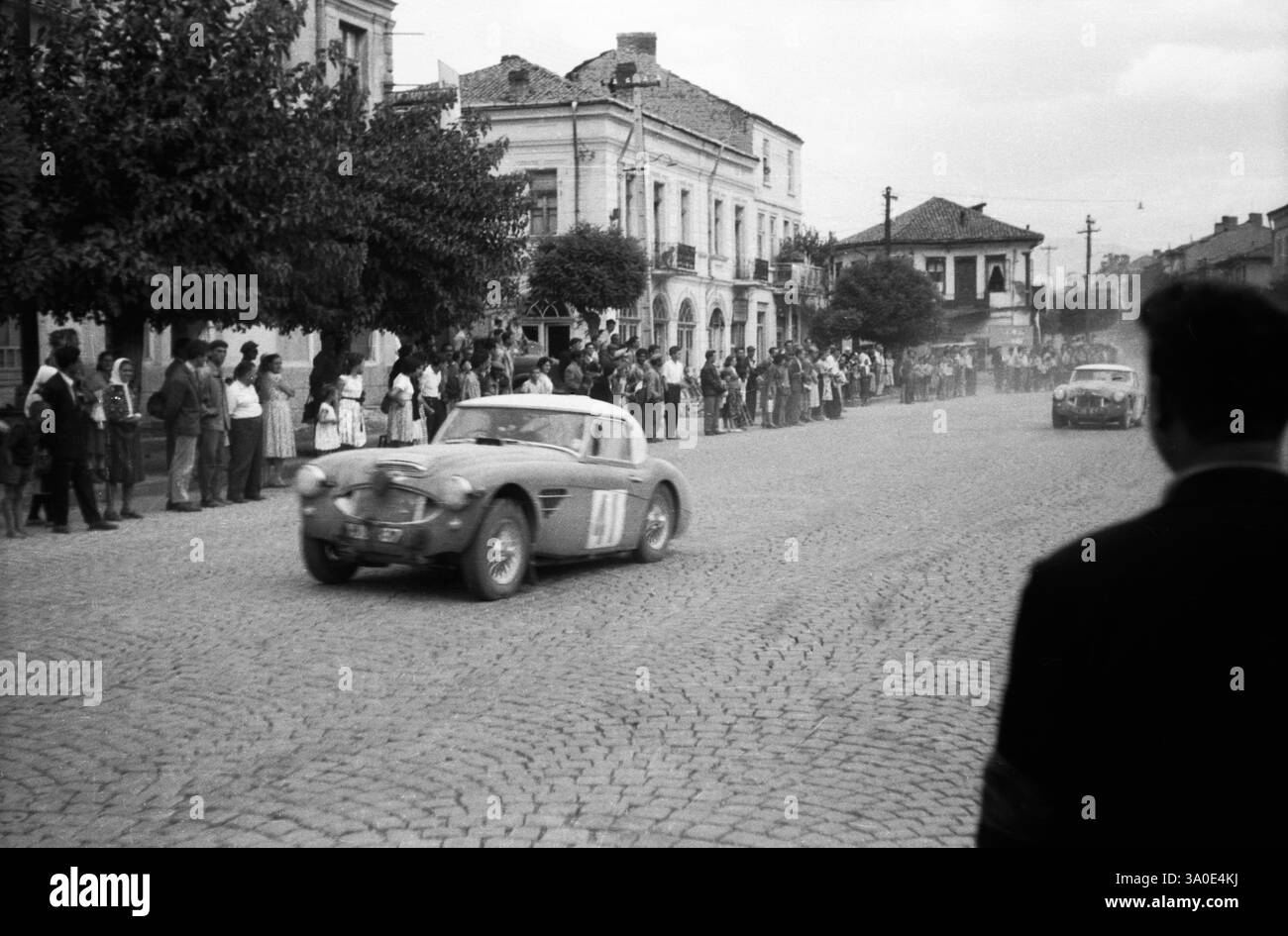 Liege-Sofia-Liege Rally, 1960s, Race car passes through the town of ...