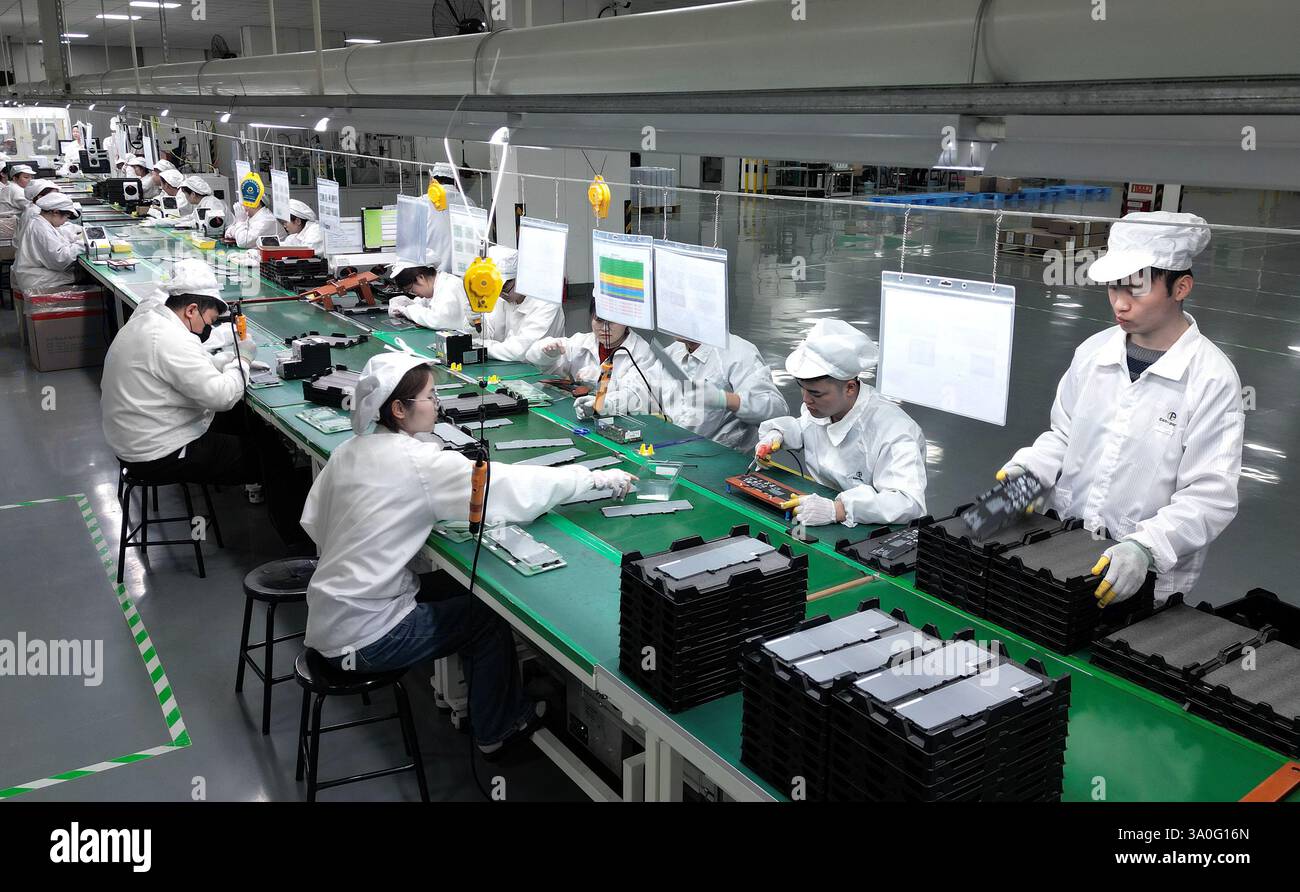 HAIAN, CHINA - MARCH 4, 2025 - A worker produces consumer lithium battery products in a workshop in Hai'an, Jiangsu province, China, March 4, 2025. Stock Photo