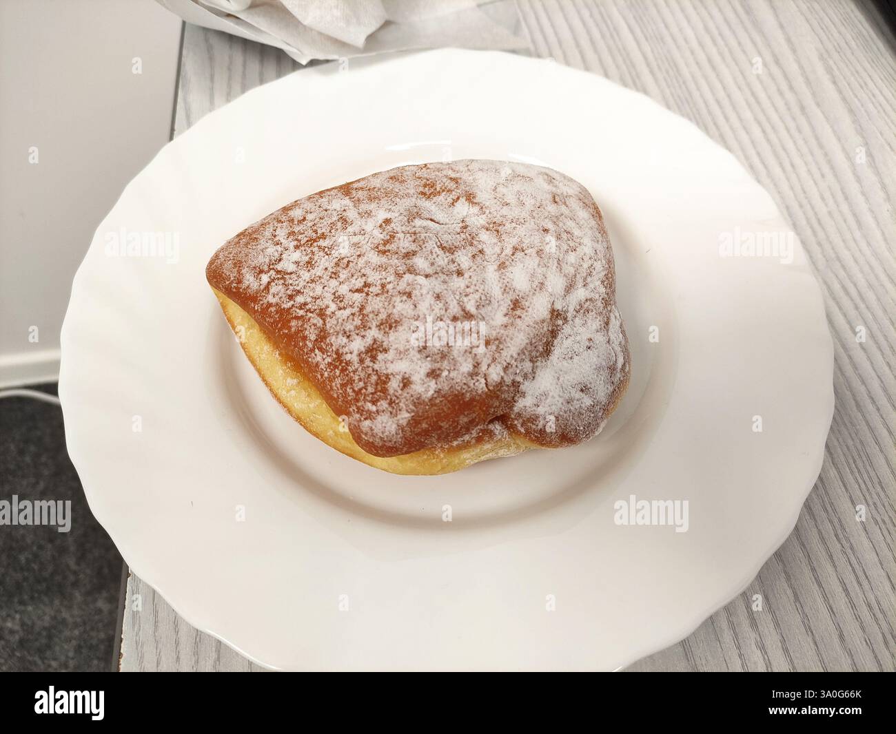 Donut with powdered sugar on a plate - Smartphone Captured Stock Image