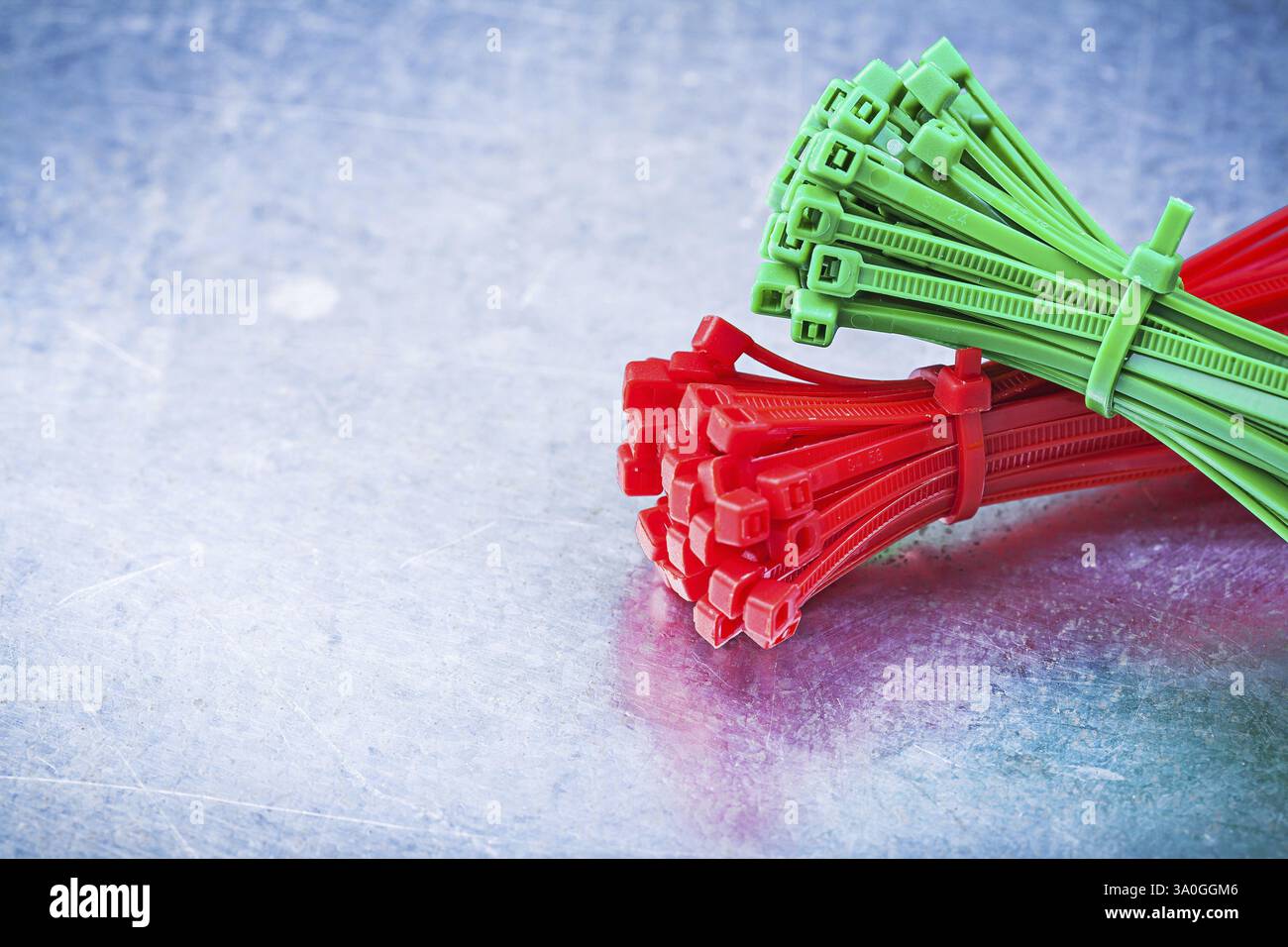 Bundle of self-locking cable ties on metallic background construction concept Stock Photo
