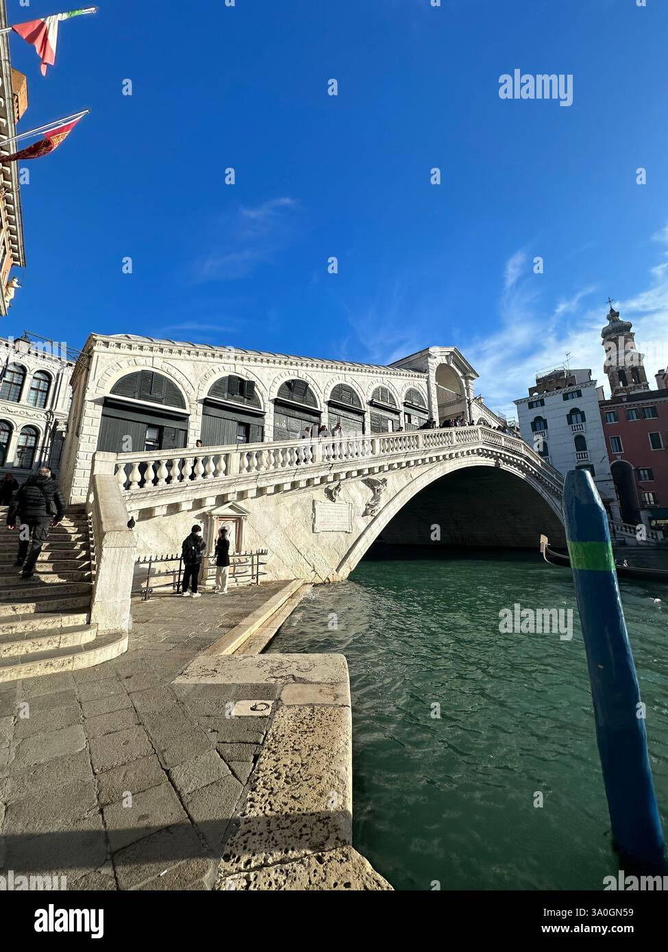 Gondola ride on the Grand Canal approaching the iconic Rialto Bridge in Venice, Italy, during golden hour - Smartphone Captured Stock Image