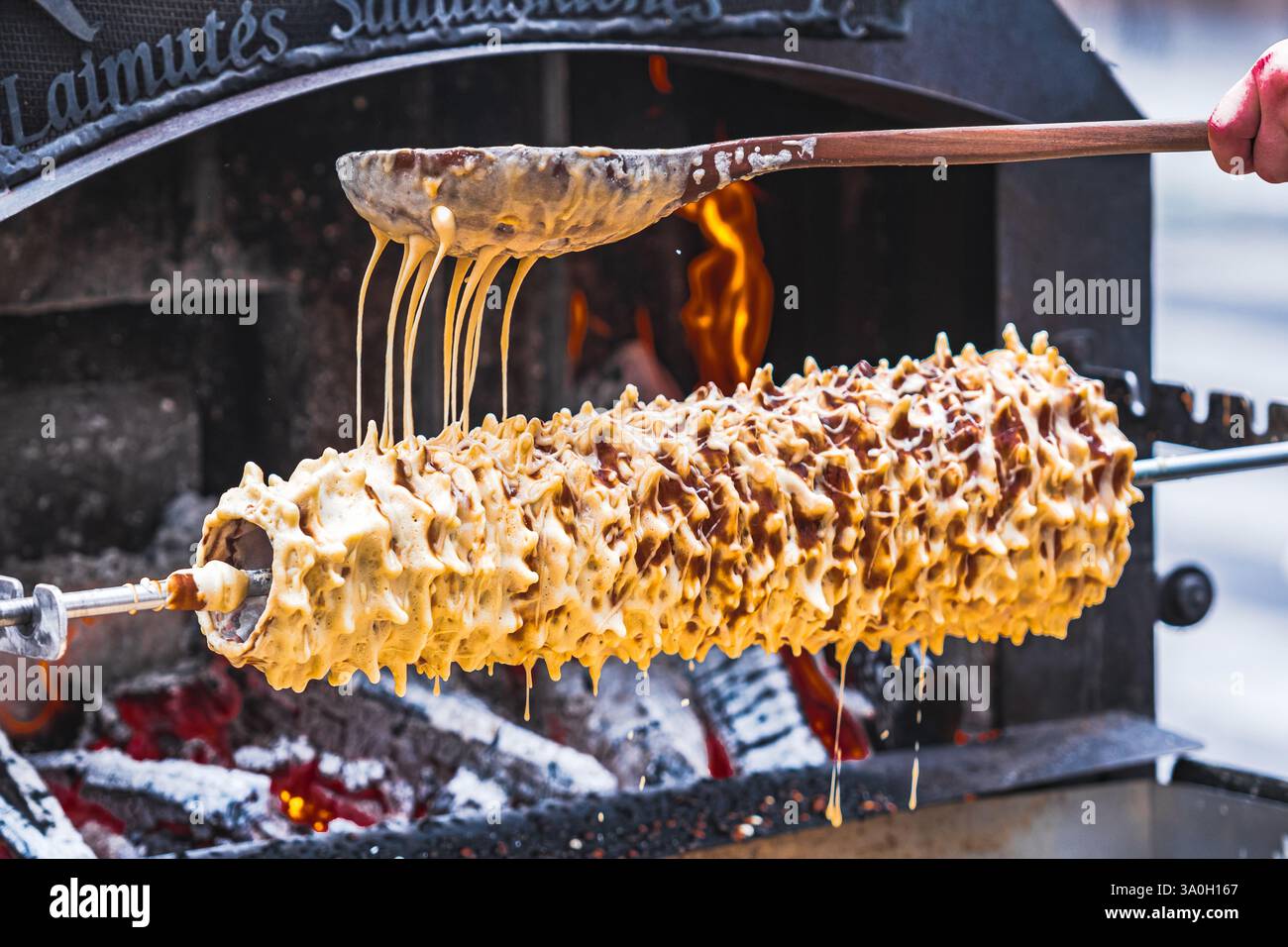 Initial stage of preparation of a tree cake, Lithuanian šakotis, Polish sękacz, Belarusian bankucha, German baumkuchen made of butter, eggs Stock Photo