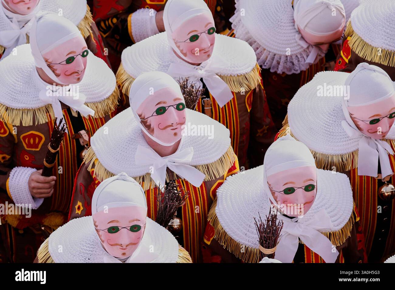 The Gilles of Binche wear their traditional wax masks as they attend ...