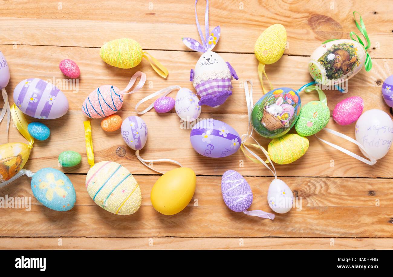 colorful Easter eggs on a wooden table top view. Easter decoration Stock Photo