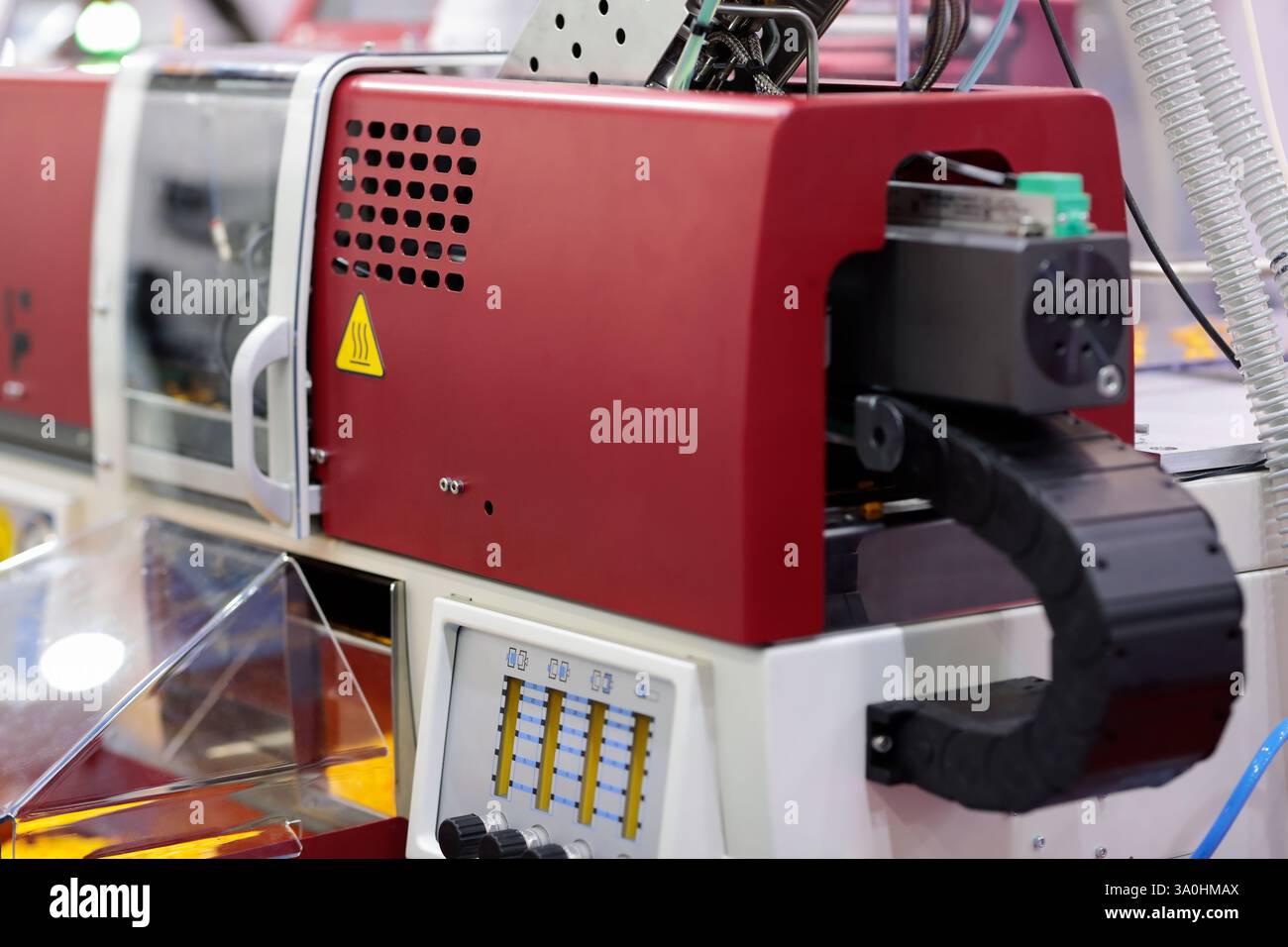 Small automatic plastic injection molding machine closeup. Selective focus. Stock Photo