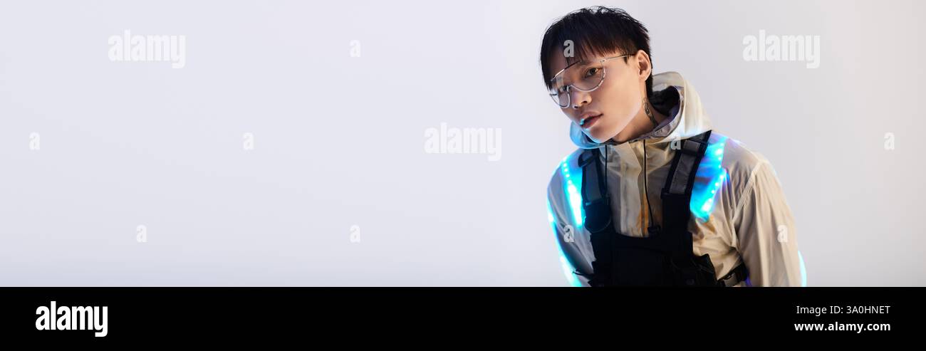 Confident young Asian man showcases modern fashion in a sleek setting ...