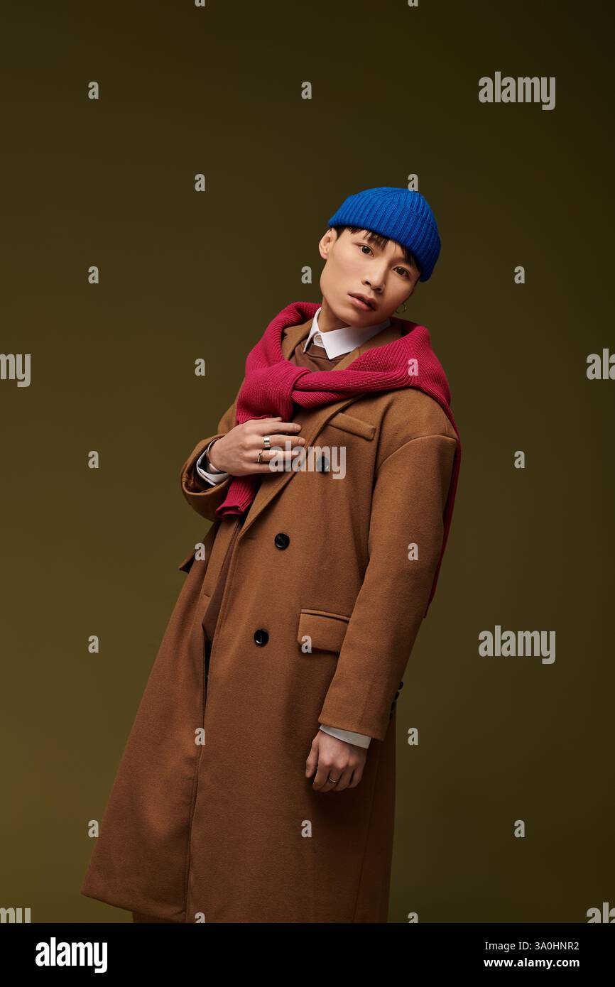 A stylish young man poses confidently, showcasing his unique flair ...