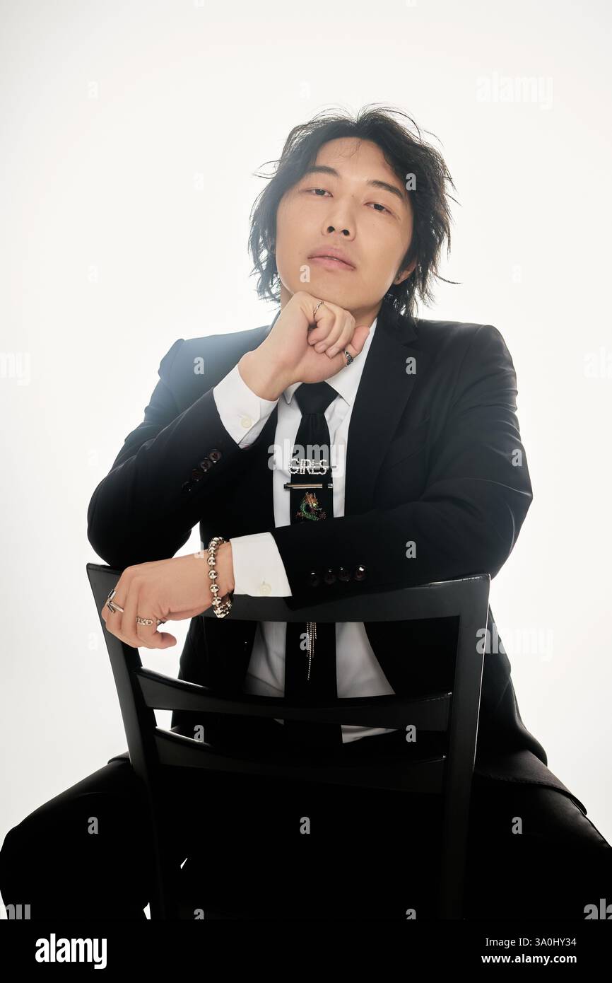 Handsome young man poses confidently while wearing a modern suit ...