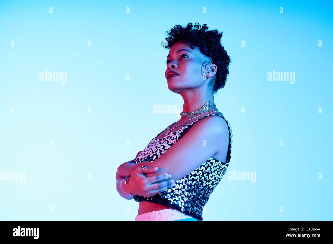 Curly haired African American woman showcases her trendy style with elegance and poise. Stock Photo