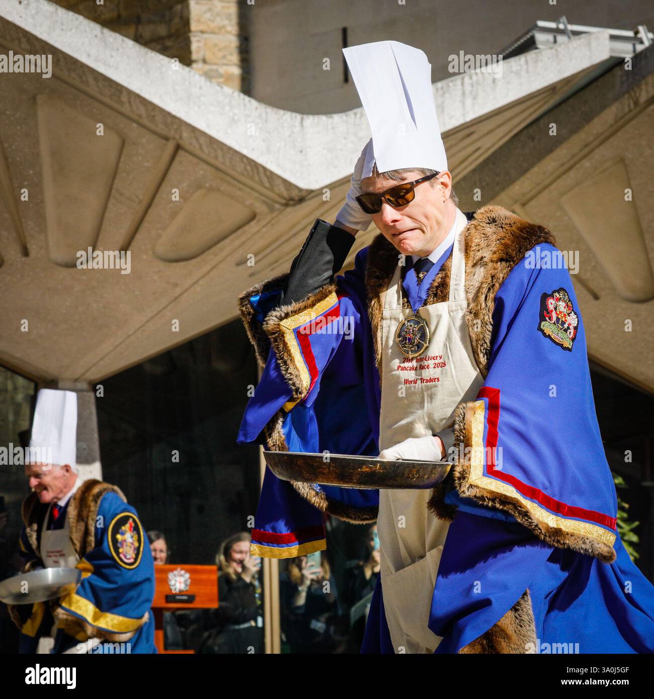 London, UK. 04th Mar, 2025. Participants from the City of London's Worshipful Companies, many in either fun costumes or outfits relating to their profession, take part in traditional Shrove Tuesday pancake races, pancake tossing and related fun at Guildhall Yard today. Credit: Imageplotter/Alamy Live News Stock Photo