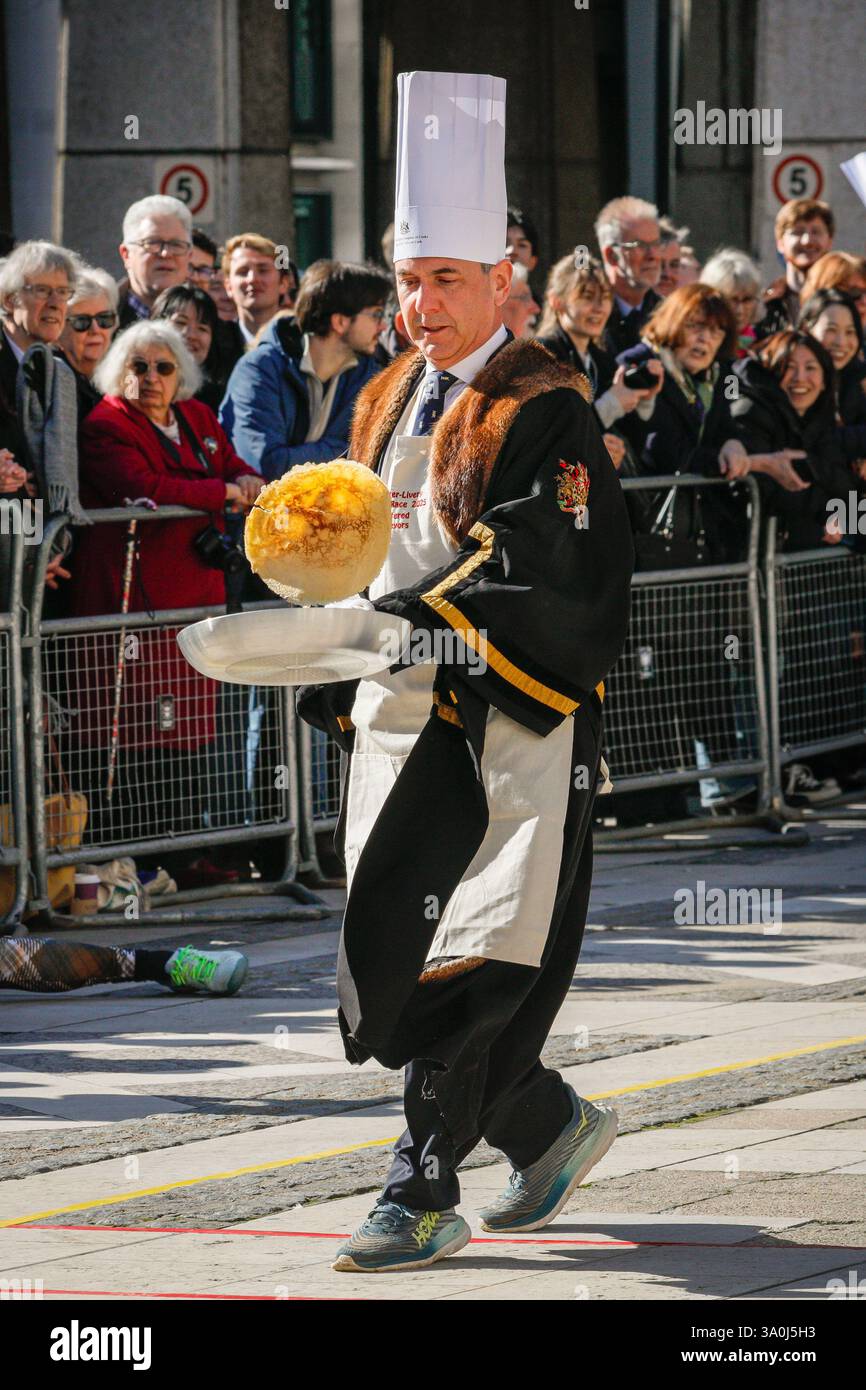 London, UK. 04th Mar, 2025. Participants from the City of London's Worshipful Companies, many in either fun costumes or outfits relating to their profession, take part in traditional Shrove Tuesday pancake races, pancake tossing and related fun at Guildhall Yard today. Credit: Imageplotter/Alamy Live News Stock Photo
