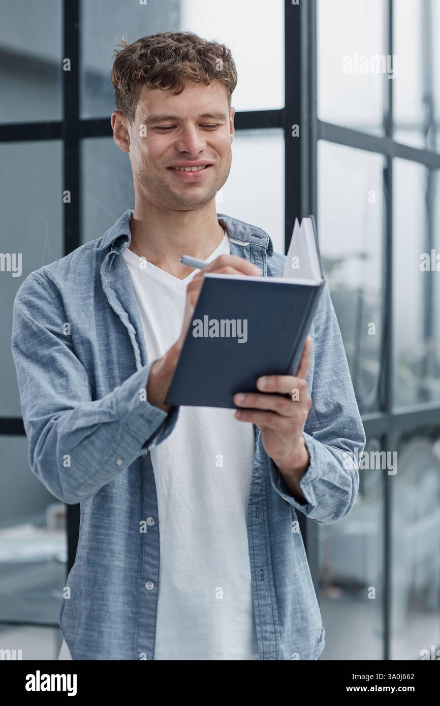 young office man at workplace making notes Stock Photo