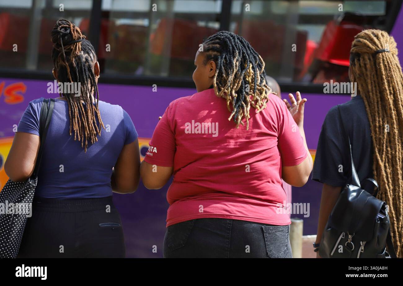 Women walk in the streets of Nairobi, Kenya, during World Obesity Day
