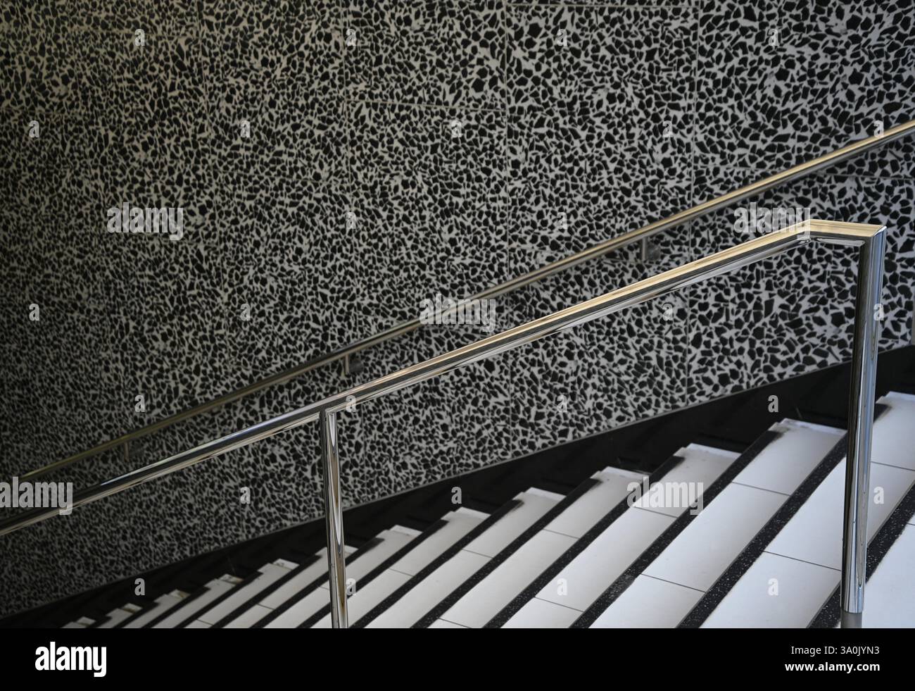 Public building futuristic staircase with an inox railing in the ...