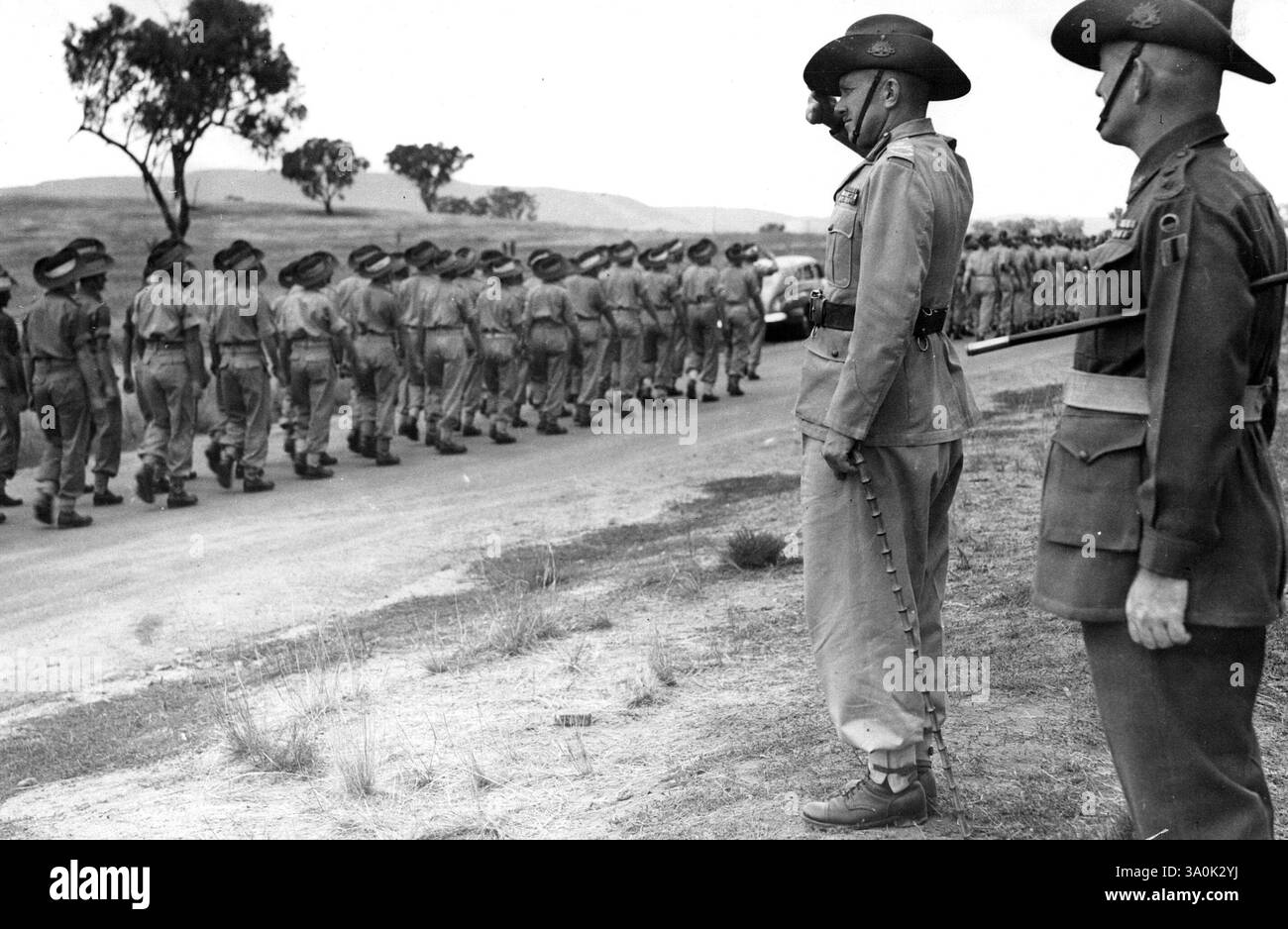 Lt. General F. H. Berryman, G.O.C. Eastern Command, takes the salute from a platoon of volunteers for the occupational forces in Japan. These volunteers, comprising mainly of new recruits have not yet been issued with rifles or webbing. There are 4400 occupational forces troops in the camp. March 13, 1946. Stock Photo
