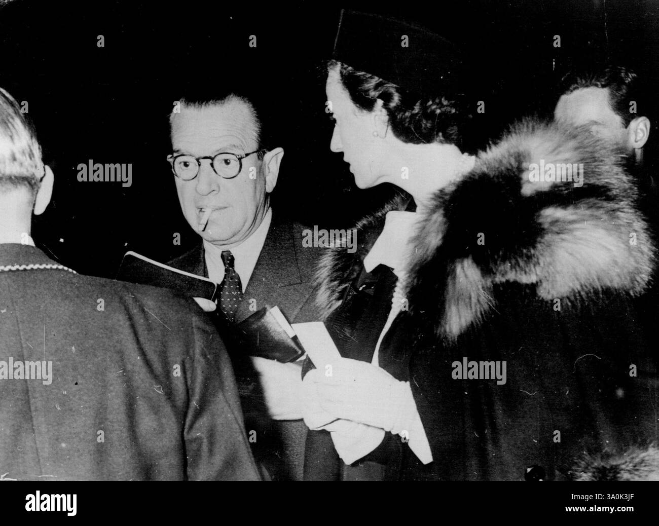 Mr. Bedeaux Arrives In New York To Arrange Duke Of Windsor's Tour -- Seen passing the immigration officers after their arrival on the S.S. Europa in New York from Europe are Mr. and Mrs. Charles Eugene Bedeaux. Mr. Bedeaux was organising the now cancelled tour of the Duke and Duchess of Windsor. November 08, 1937. (Photo by Keystone) Stock Photo