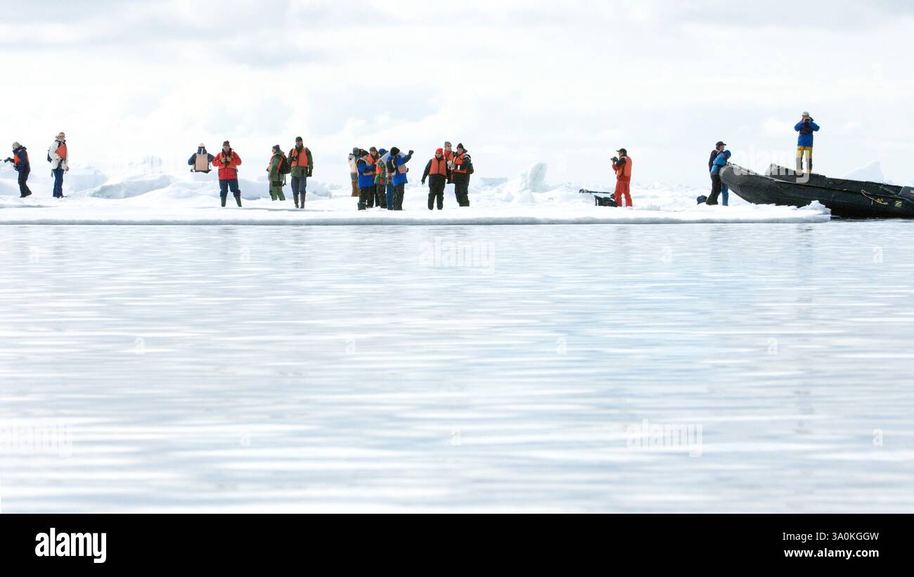 Eco-tourists landing on pack ice at almost 80-degrees north during an ...