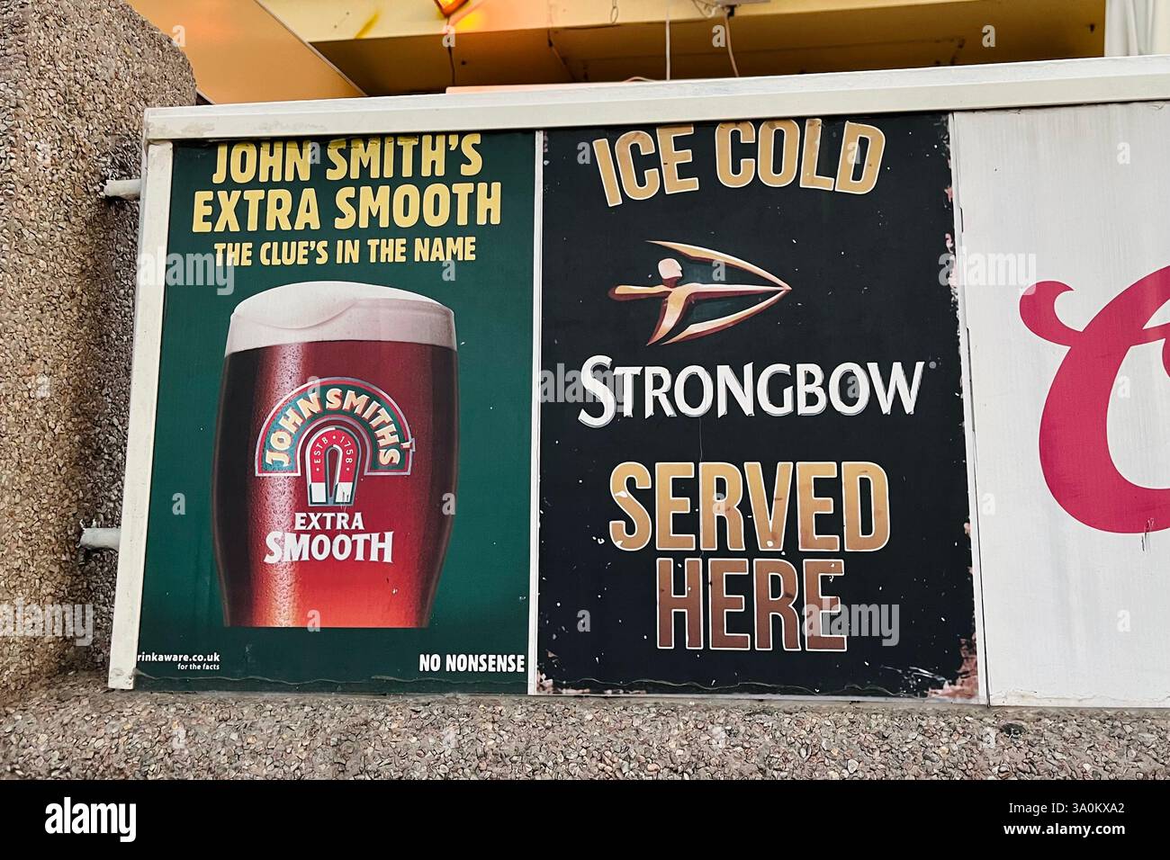 John Smith's and Strongbow Signs outside a British Pub simply called 'The Pub' in Costa Adeje. Tenerife, Canary Islands, Spain. 27th January 2025. - Smartphone Captured Stock Image