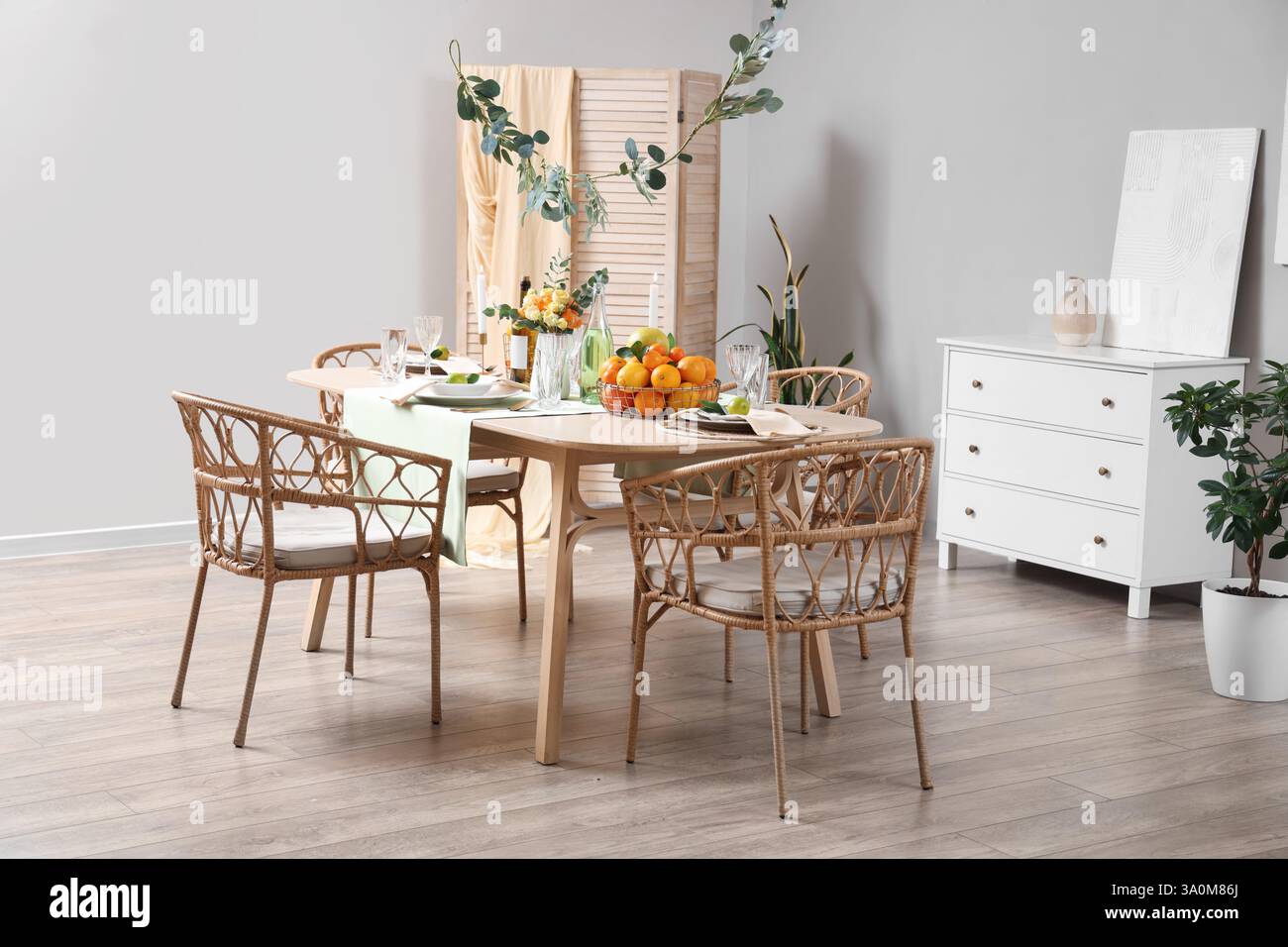 Dining table served with citrus fruits in room Stock Photo - Alamy